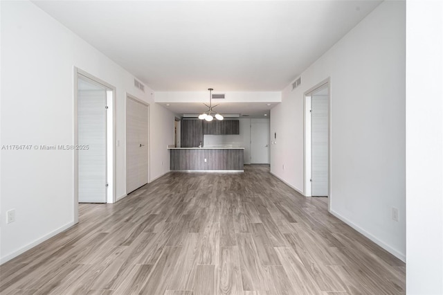 801 S Miami Ave Unit 3110, Miami, FL 33130 - unfurnished living room featuring light wood-style flooring and a chandelier