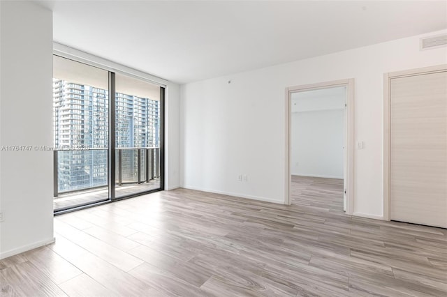 801 S Miami Ave Unit 3110, Miami, FL 33130 - unfurnished room with a wall of windows and light wood finished floors
