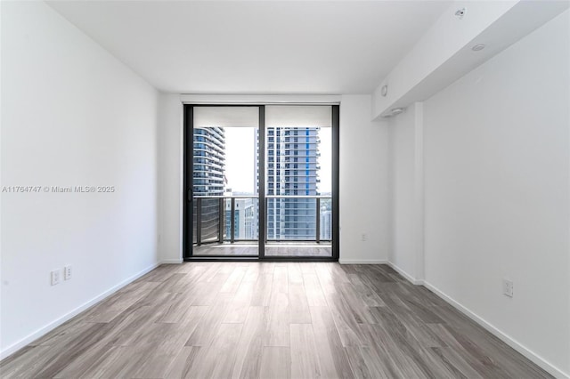 801 S Miami Ave Unit 3110, Miami, FL 33130 - empty room with floor to ceiling windows and wood finished floors