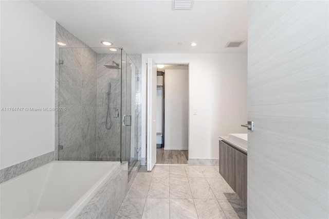 801 S Miami Ave Unit 3110, Miami, FL 33130 - bathroom with a shower stall, vanity, a bath, and recessed lighting