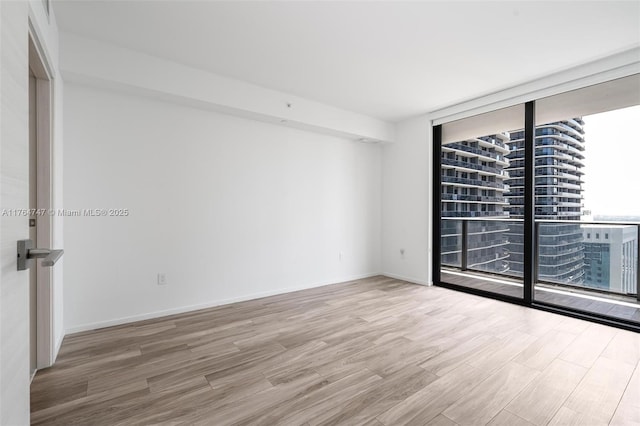 801 S Miami Ave Unit 3110, Miami, FL 33130 - spare room with floor to ceiling windows and wood finished floors