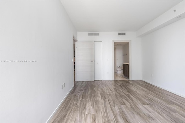 801 S Miami Ave Unit 3110, Miami, FL 33130 - unfurnished bedroom with light wood-type flooring and ensuite bath
