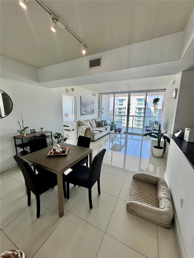 dining space with light tile patterned floors, visible vents, and baseboards