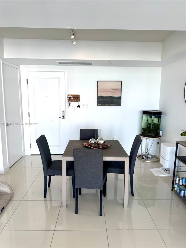 dining room featuring light tile patterned floors and visible vents