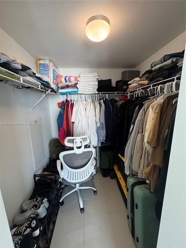 spacious closet with tile patterned floors