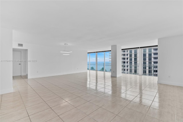 600 Grapetree Dr Unit 8Cs, Key Biscayne, FL 33149 - unfurnished room featuring light tile patterned floors, floor to ceiling windows, and baseboards