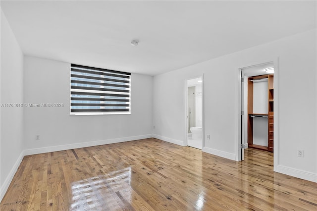 600 Grapetree Dr Unit 8Cs, Key Biscayne, FL 33149 - unfurnished bedroom featuring a spacious closet, wood finished floors, and baseboards