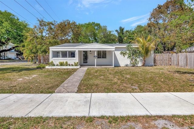 843 SW 20th St, Fort Lauderdale, FL 33315 - view of front of house featuring covered porch, stucco siding, a front yard, and fence