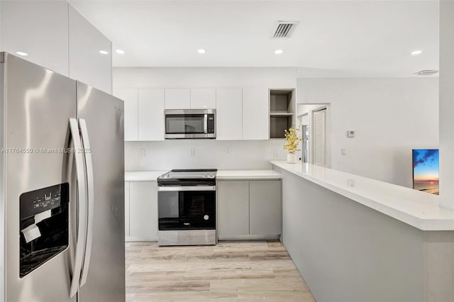 843 SW 20th St, Fort Lauderdale, FL 33315 - kitchen with open shelves, light countertops, visible vents, and stainless steel appliances