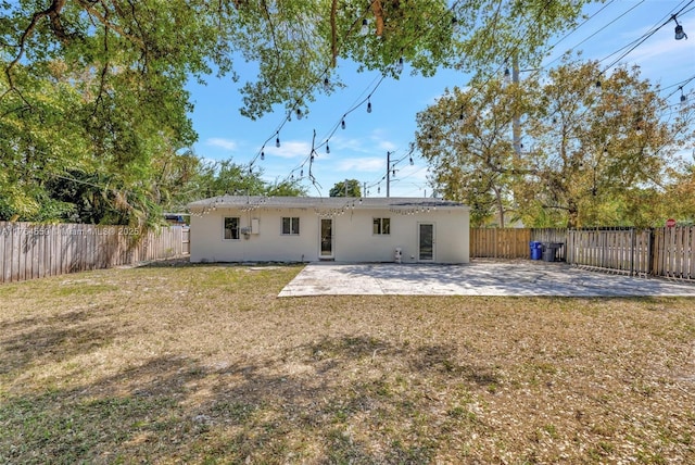 843 SW 20th St, Fort Lauderdale, FL 33315 - rear view of house with a yard, a fenced backyard, stucco siding, and a patio area
