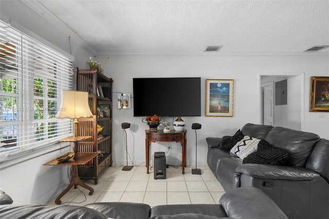 living room with crown molding, visible vents, and light tile patterned floors