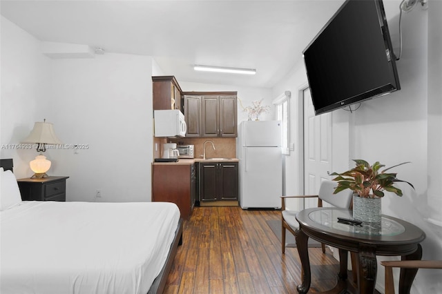 bedroom with a toaster, dark wood-style floors, a sink, and freestanding refrigerator