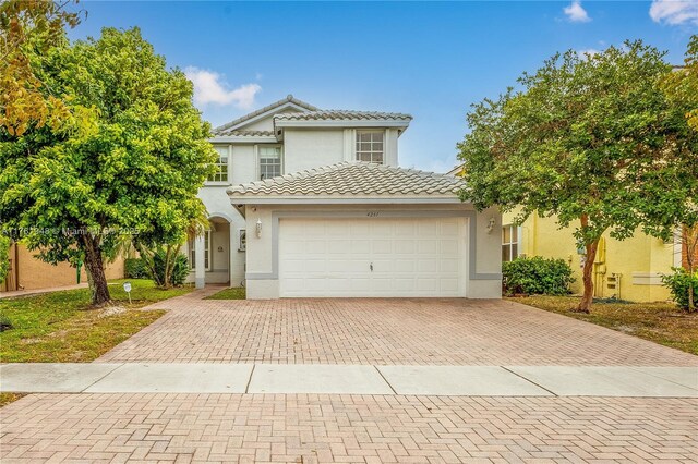 4261 SW 126th Ave, Miramar, FL 33027 - view of front of home with decorative driveway, an attached garage, a tile roof, and stucco siding