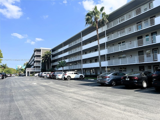 view of building exterior with uncovered parking