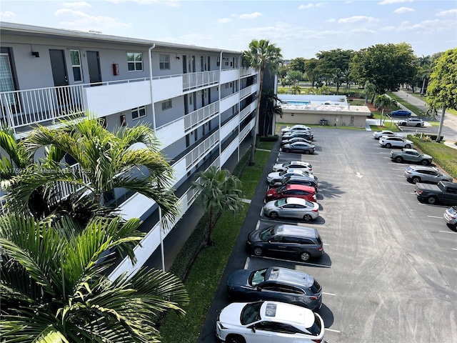 view of building exterior with uncovered parking