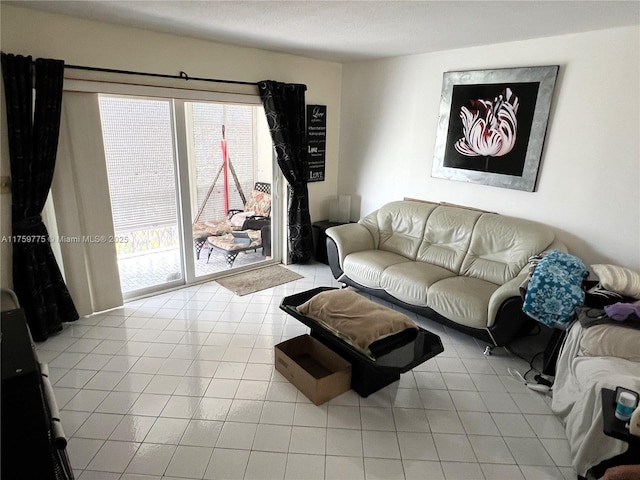 living area featuring plenty of natural light and tile patterned flooring