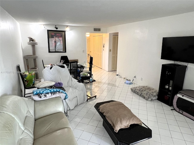 living area with light tile patterned flooring and visible vents
