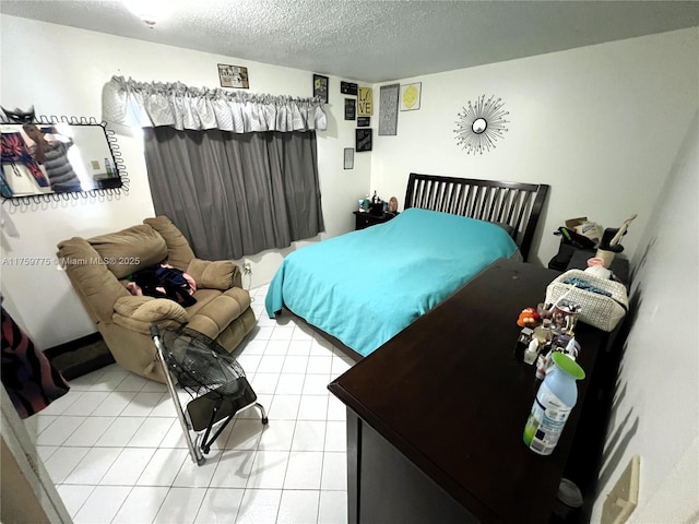 bedroom featuring a textured ceiling and light tile patterned floors
