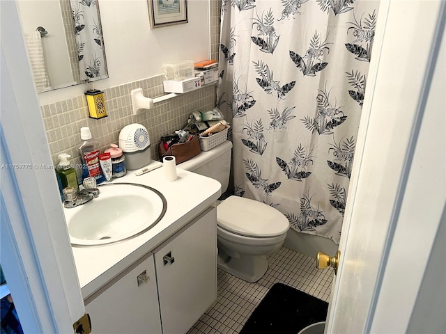 full bathroom with tile patterned floors, toilet, tile walls, a shower with shower curtain, and vanity