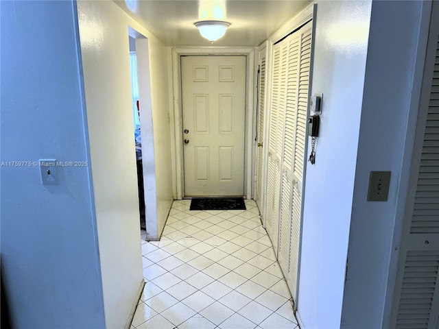 hall featuring light tile patterned floors