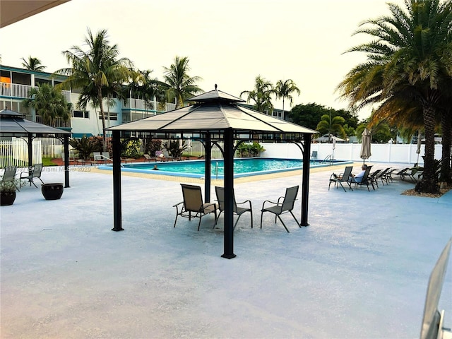 pool with a gazebo and fence