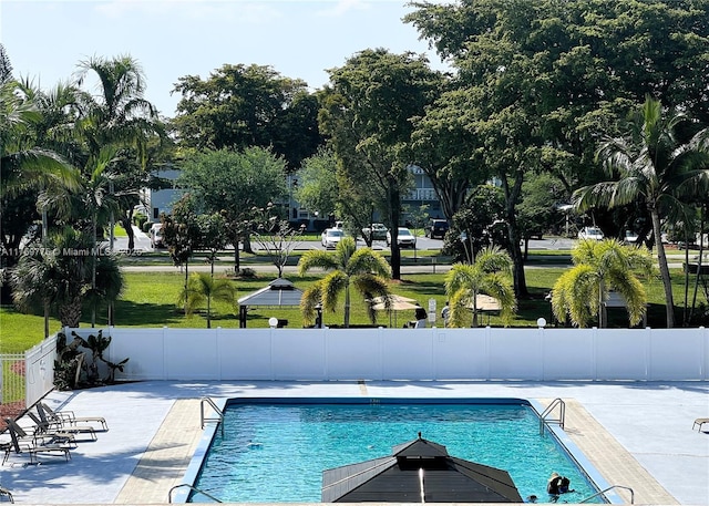 pool with fence and a patio area