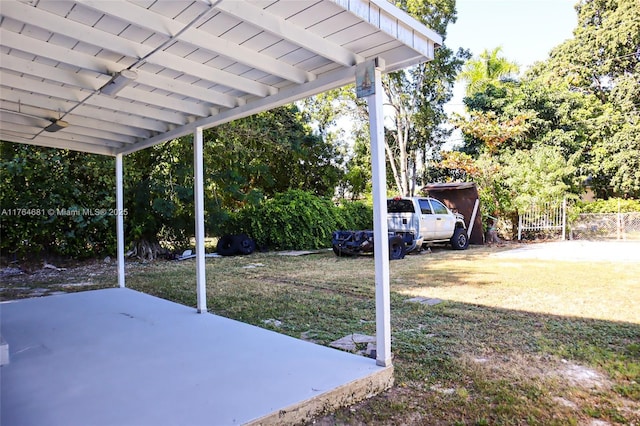 view of yard featuring a ceiling fan, a patio, and fence