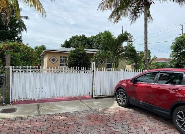 view of front of home with a fenced front yard and stucco siding