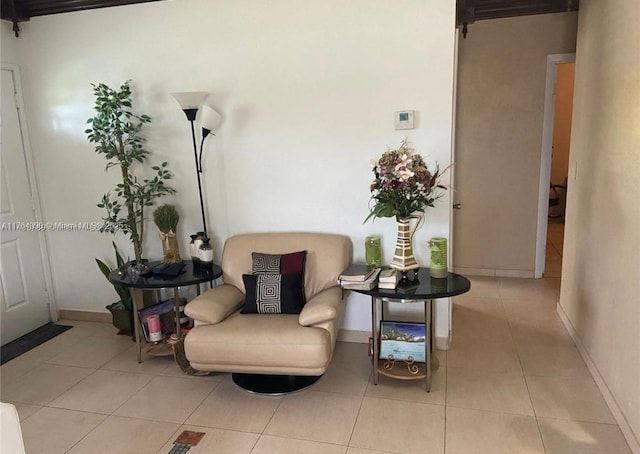 living area featuring tile patterned flooring and baseboards