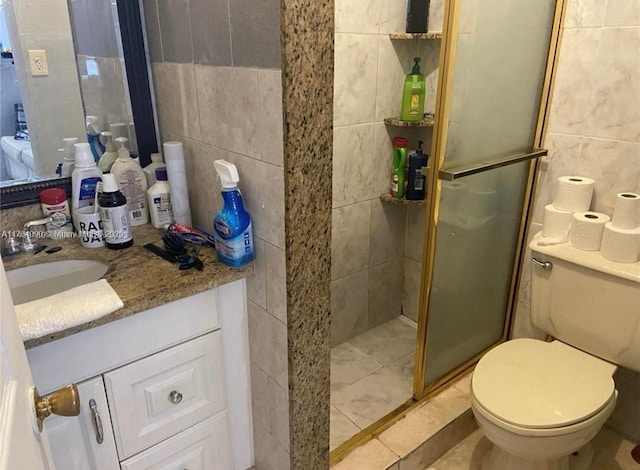 full bath with toilet, a stall shower, tile walls, tile patterned flooring, and vanity