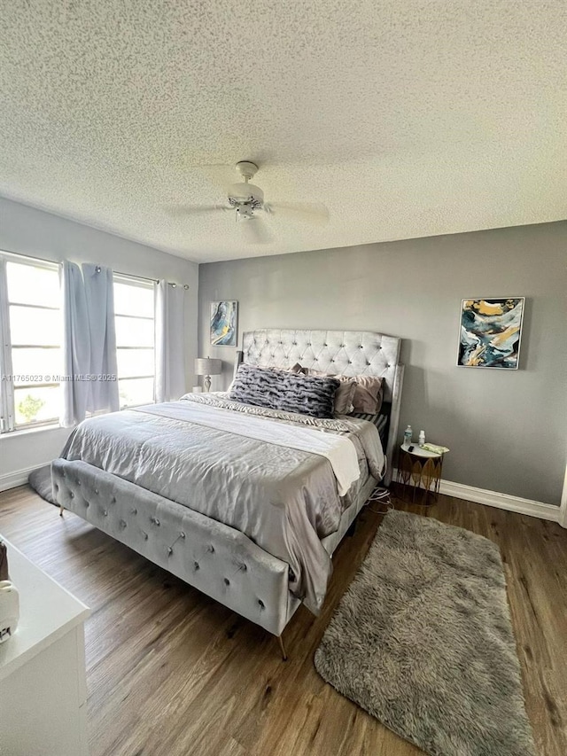 1101 Crystal Lake Dr Unit 602, Deerfield Beach, FL 33064 - bedroom featuring ceiling fan, baseboards, a textured ceiling, and wood finished floors