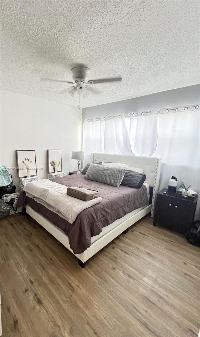 1101 Crystal Lake Dr Unit 602, Deerfield Beach, FL 33064 - bedroom with a textured ceiling, wood finished floors, and a ceiling fan