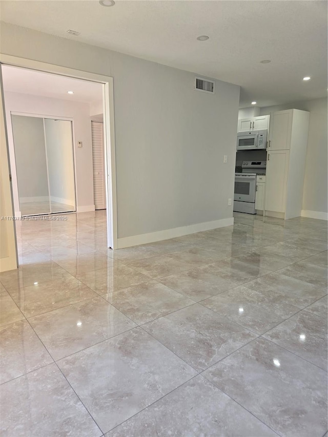 empty room featuring visible vents, marble finish floor, and baseboards