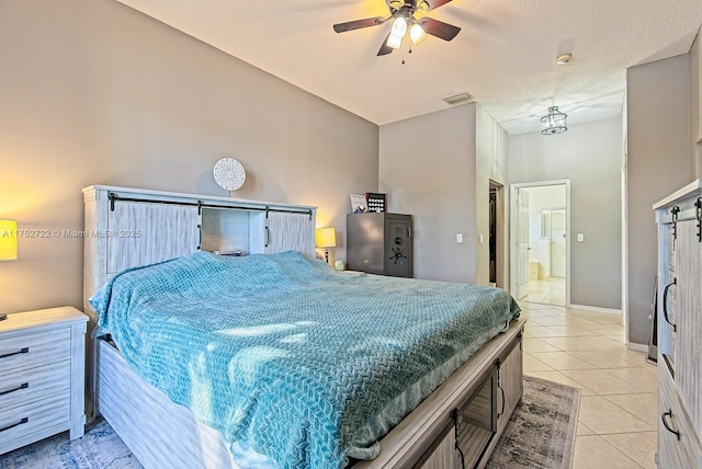 bedroom featuring light tile patterned floors, visible vents, ceiling fan, and baseboards