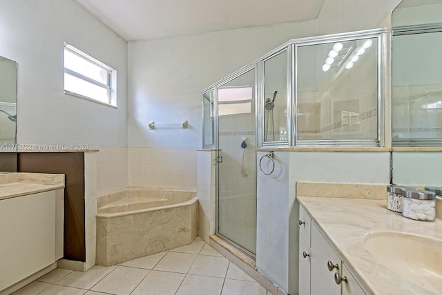 full bathroom with a garden tub, two vanities, a shower stall, and tile patterned flooring