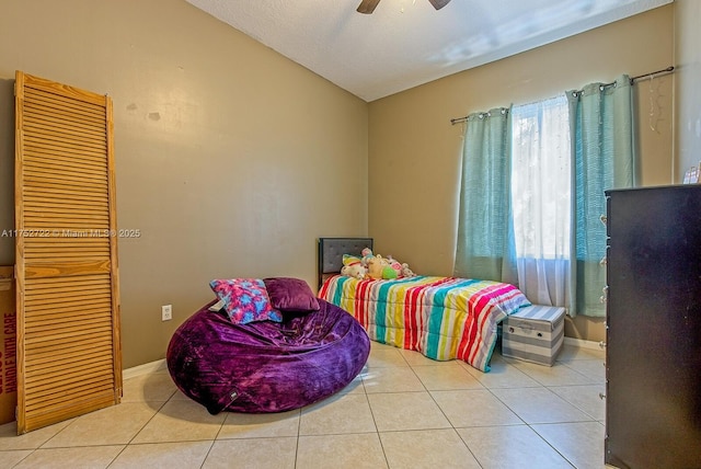 bedroom with tile patterned flooring, a ceiling fan, and vaulted ceiling