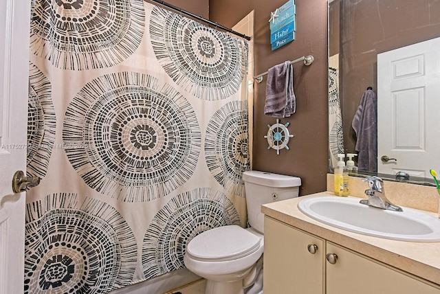 bathroom featuring curtained shower, toilet, and vanity