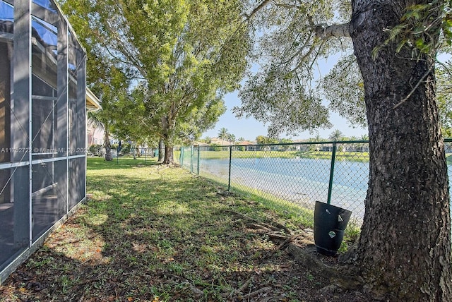 view of yard featuring a lanai and fence