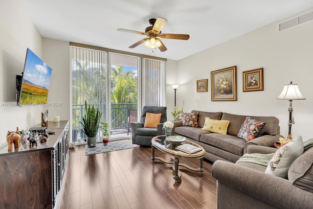 living room featuring visible vents, plenty of natural light, and wood finished floors