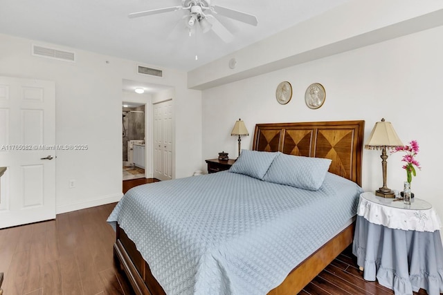 bedroom featuring dark wood finished floors, visible vents, ensuite bath, and baseboards