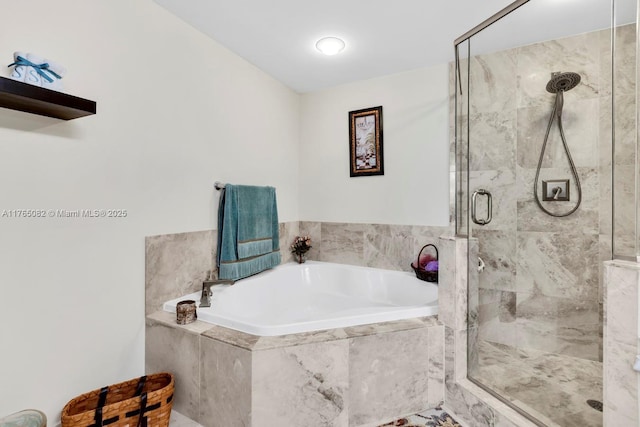bathroom with a bath and a stall shower