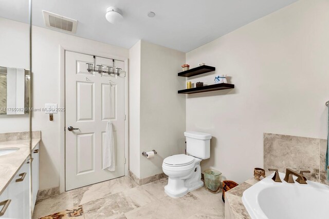 full bathroom featuring visible vents, toilet, marble finish floor, a bath, and vanity
