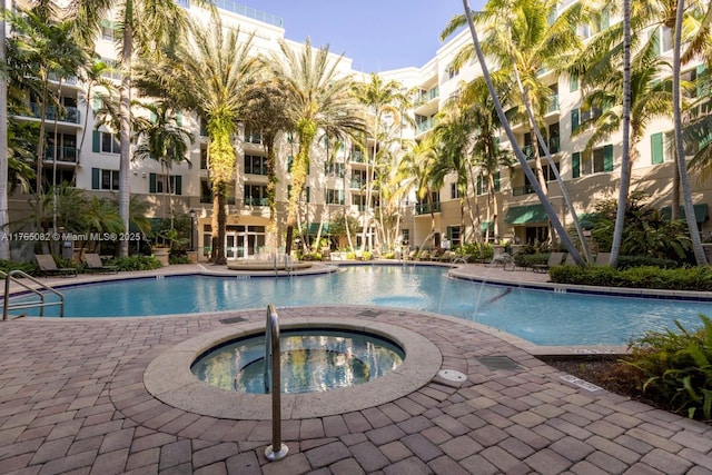 view of swimming pool with a hot tub
