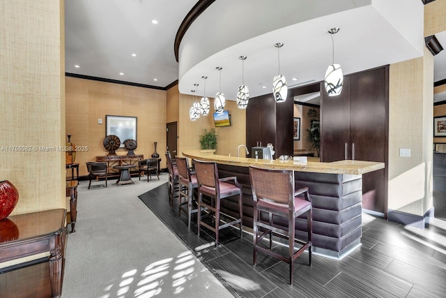 bar with recessed lighting, pendant lighting, and ornamental molding