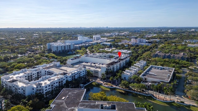 birds eye view of property with a water view and a city view