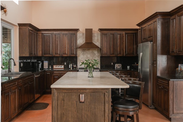 12301 SW 107th Ave, Miami, FL 33176 - kitchen with a sink, wall chimney exhaust hood, appliances with stainless steel finishes, decorative backsplash, and dark brown cabinets