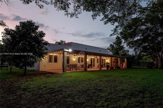 12301 SW 107th Ave, Miami, FL 33176 - back of property with a yard, a patio, and stucco siding