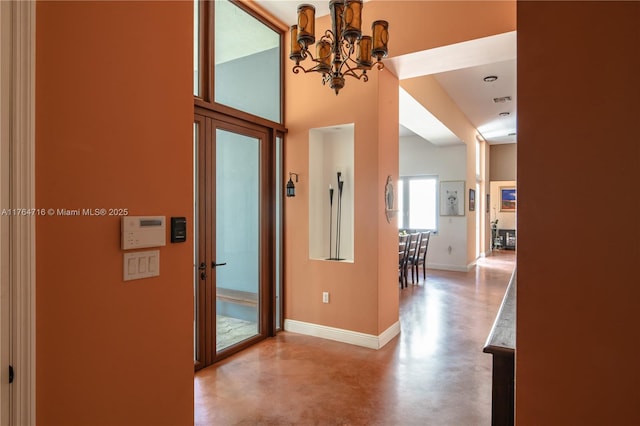 12301 SW 107th Ave, Miami, FL 33176 - entrance foyer with finished concrete floors, a chandelier, baseboards, and a towering ceiling