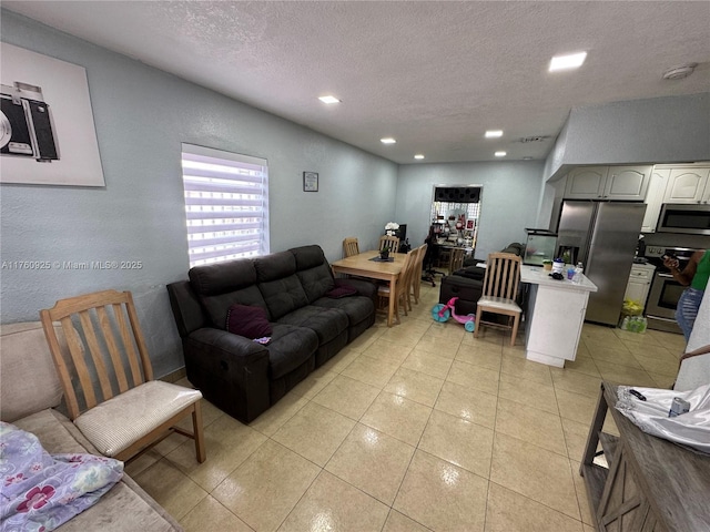 825 E 9th Ln, Hialeah, FL 33010 - living room featuring a textured ceiling, light tile patterned flooring, and recessed lighting