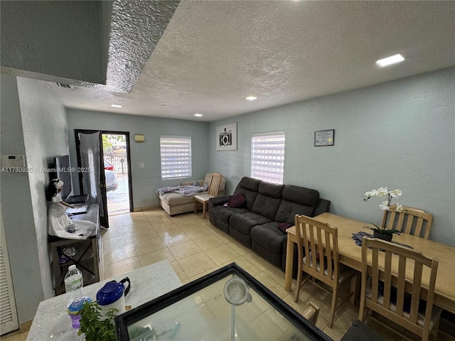 825 E 9th Ln, Hialeah, FL 33010 - living area with a textured ceiling, tile patterned flooring, and a textured wall
